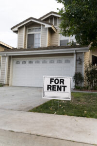 House with a for rent sign out front.